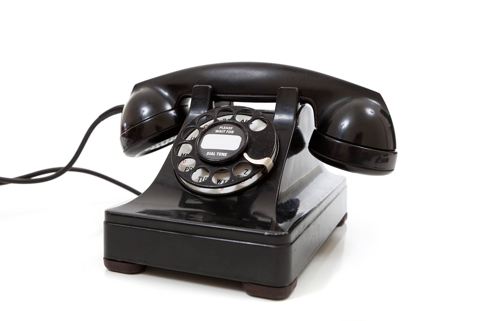 A black vintage rotary phone on a white background